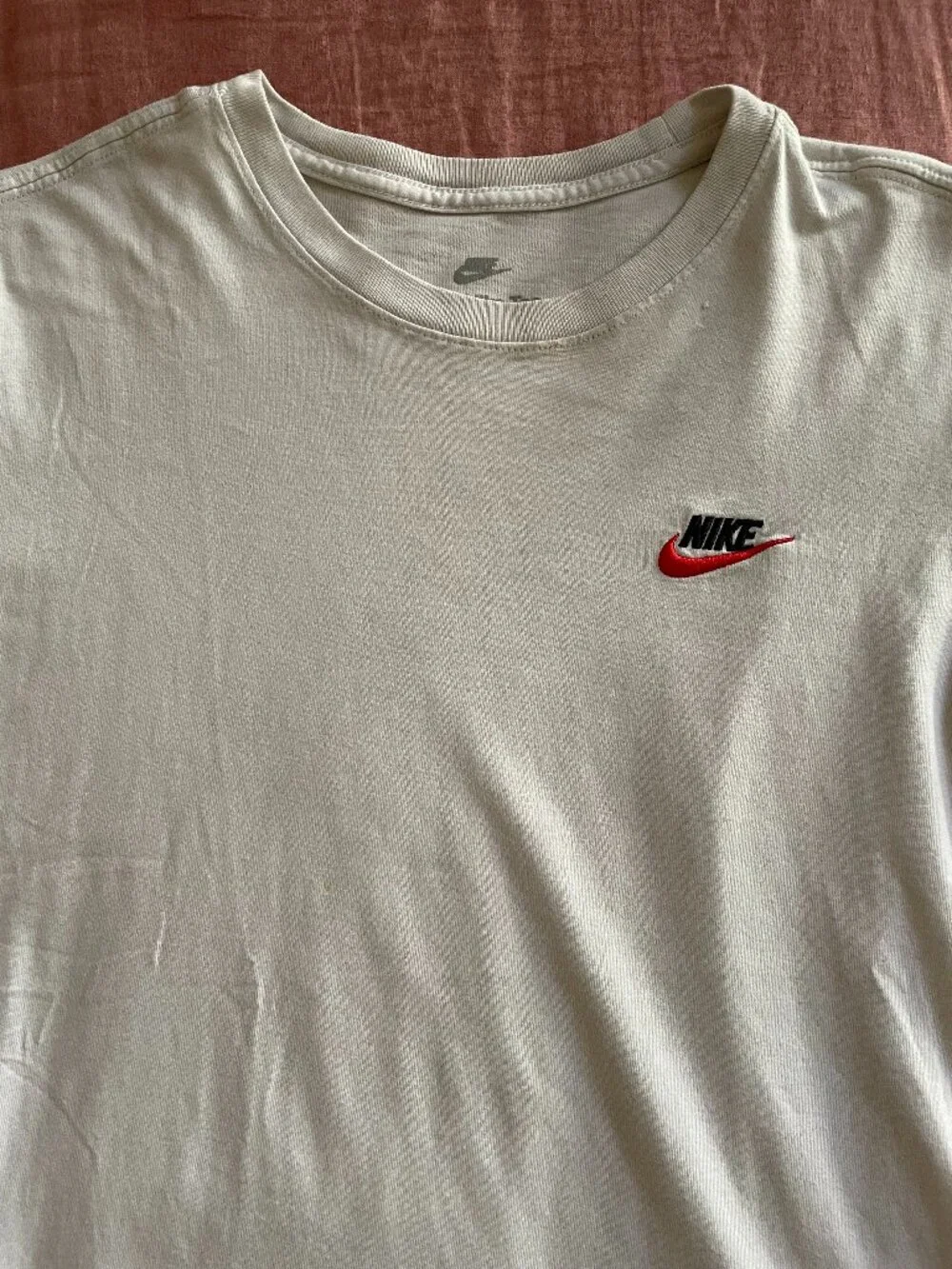 The Nike Tee With Two Red and Black Embroidered Logo - Size S